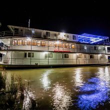 Proud Mary boat on river at night